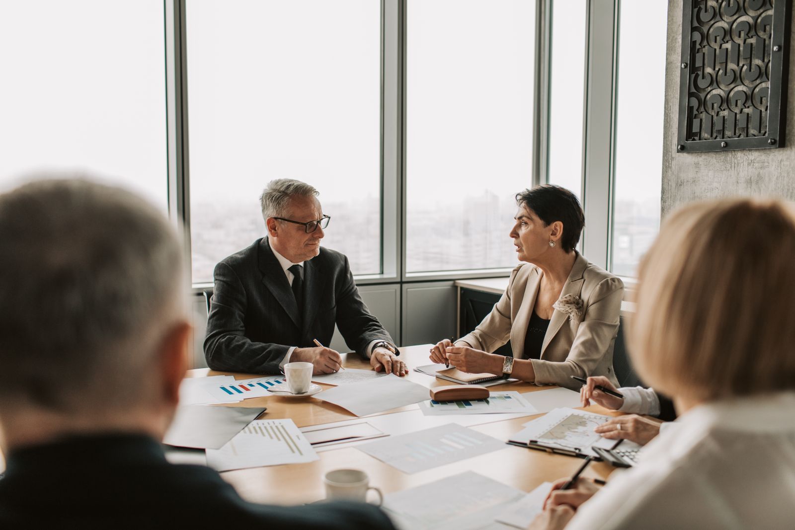 Health-system leaders in discussion around a conference table