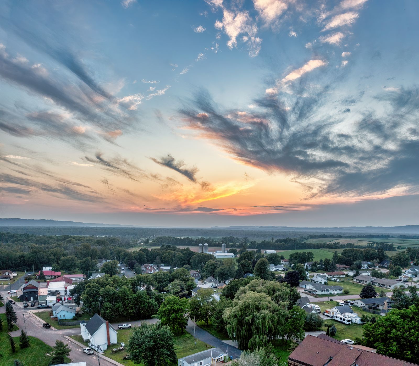 A small rural town and surrounding farmland at sunset